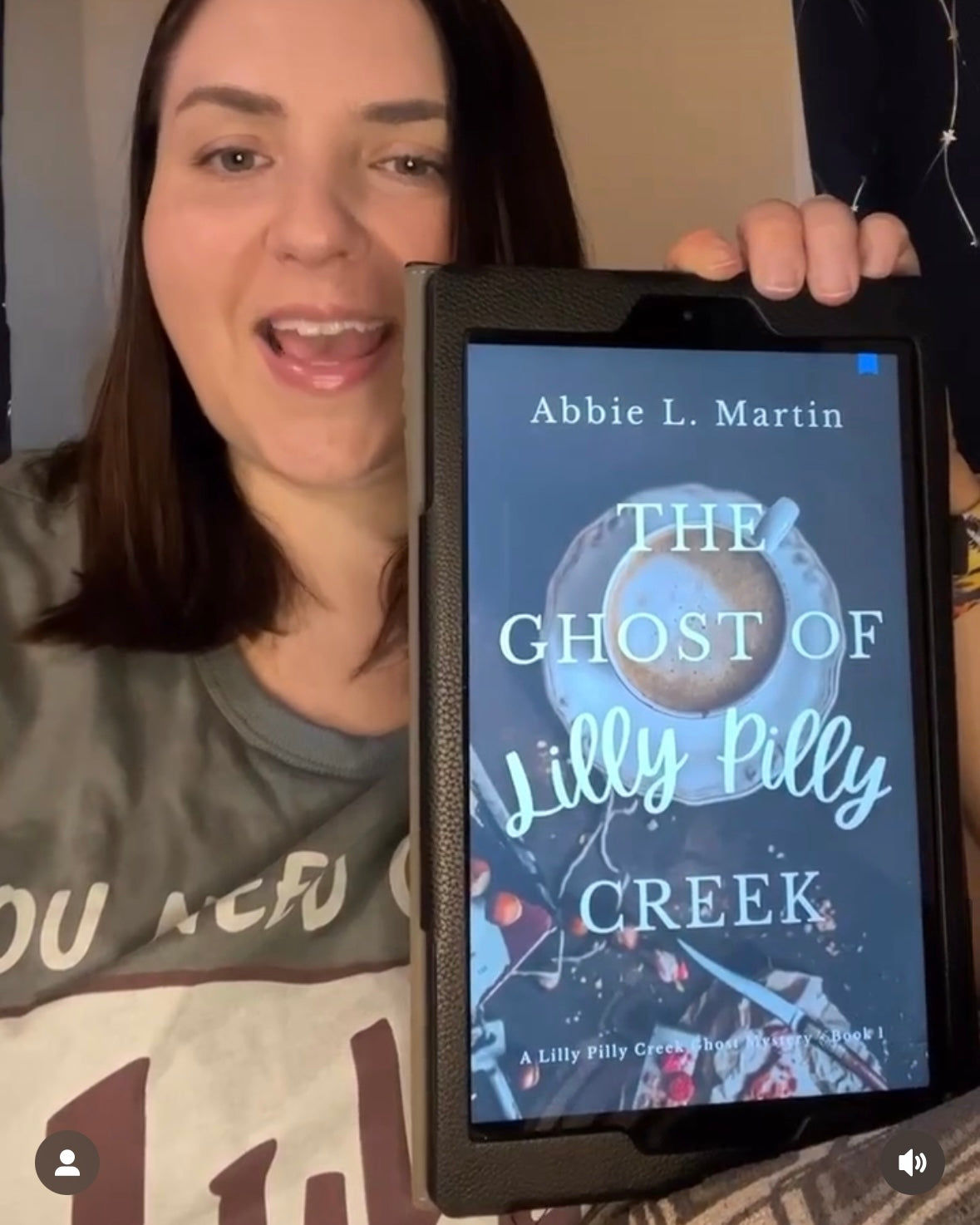 Reader with The Ghost of Lilly Pilly Creek Cozy Mystery Book
